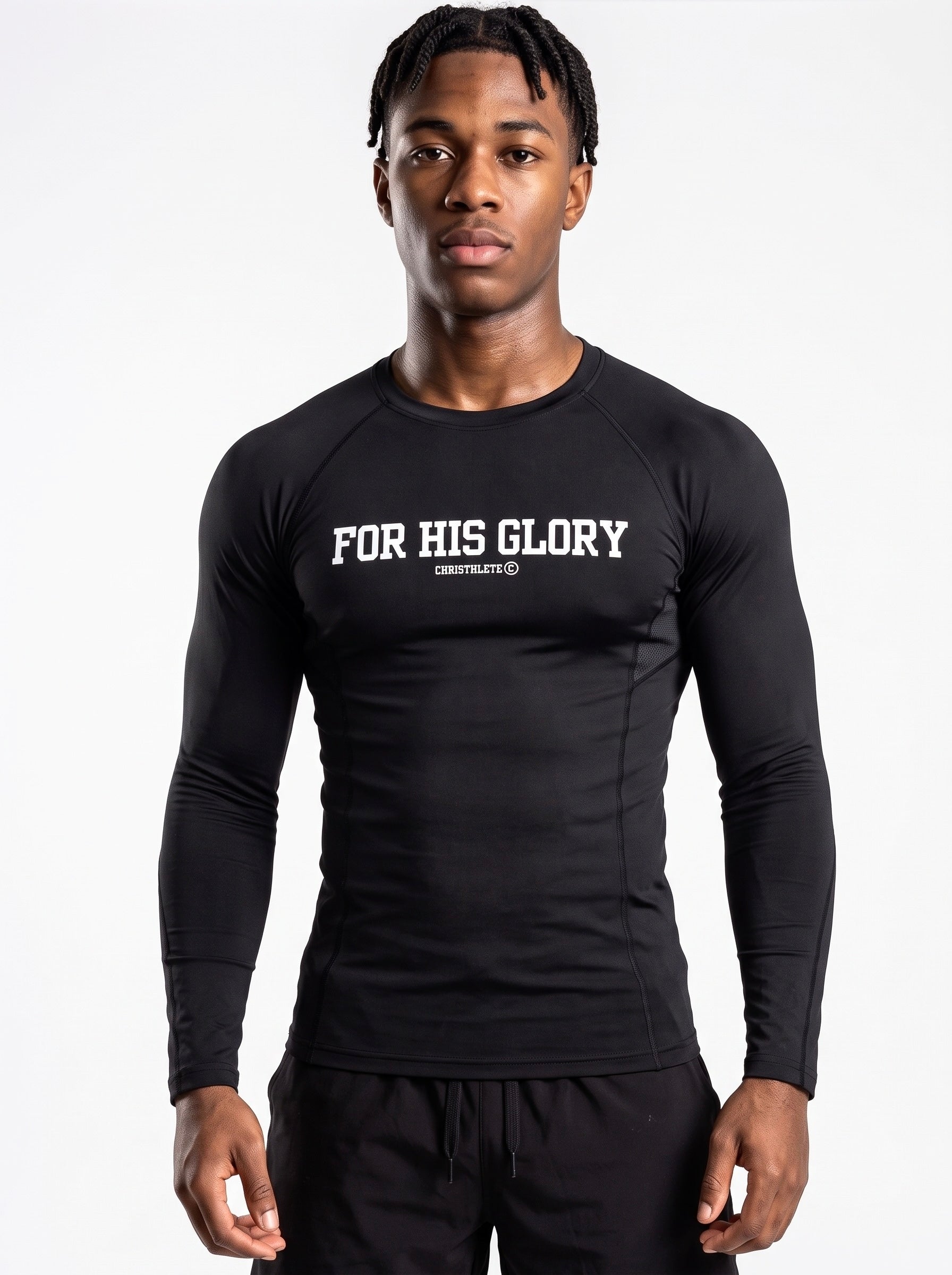 Image of A man wearing a black long-sleeve compression shirt with 'FOR HIS GLORY' printed in white across the chest, posed against a solid white studio background.