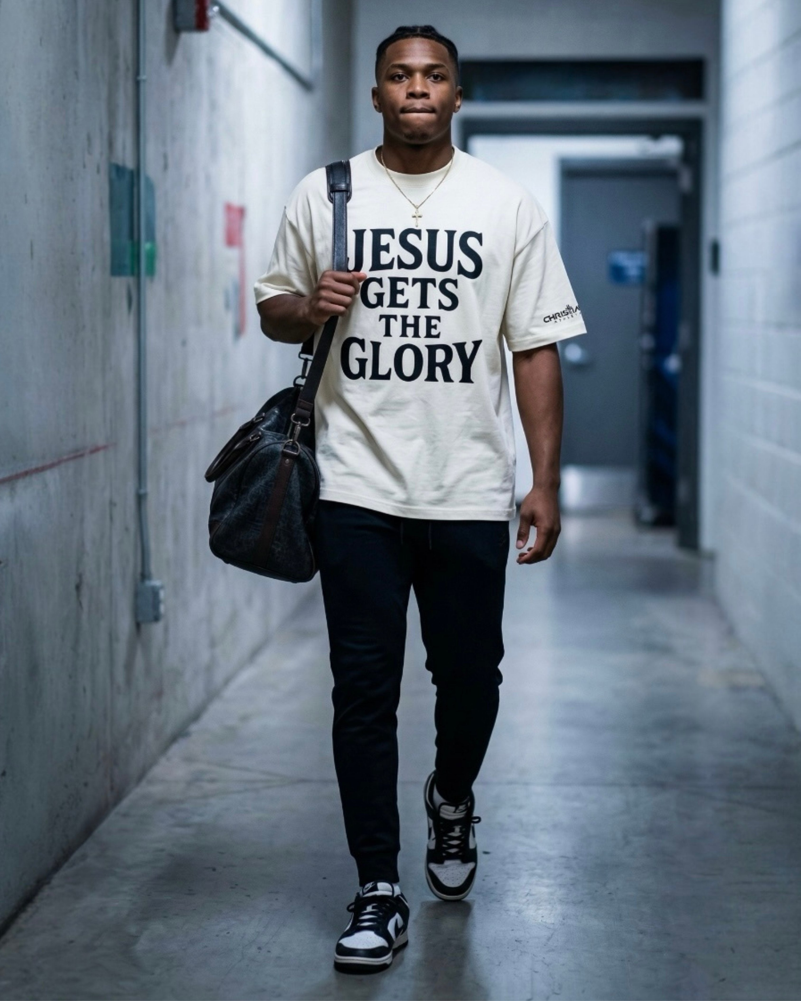 Image of Person wearing a t-shirt with 'Jesus Gets the Glory' in a hallway