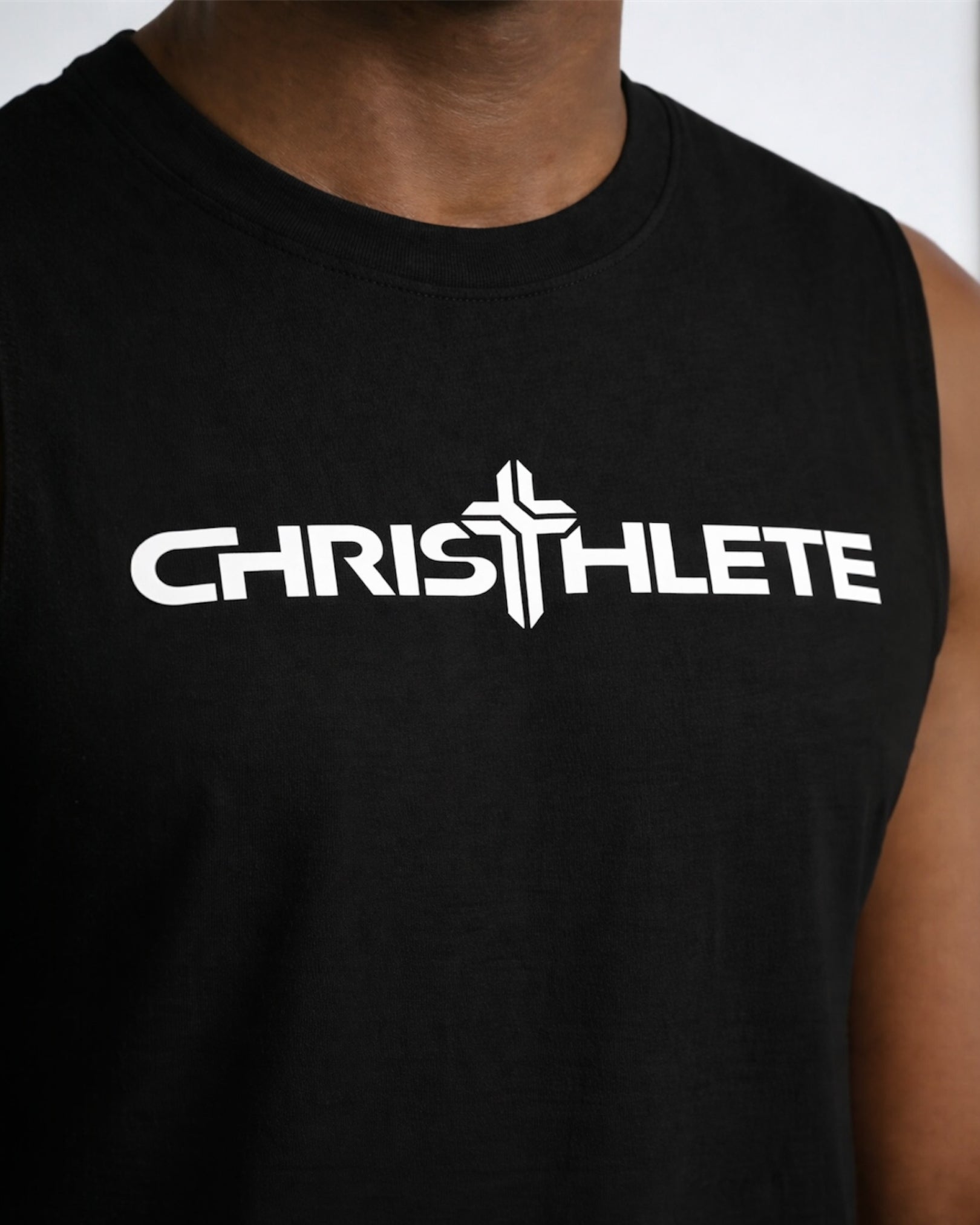Image of Black sleeveless shirt with 'CHRISTHLETE' logo on a person against a neutral background