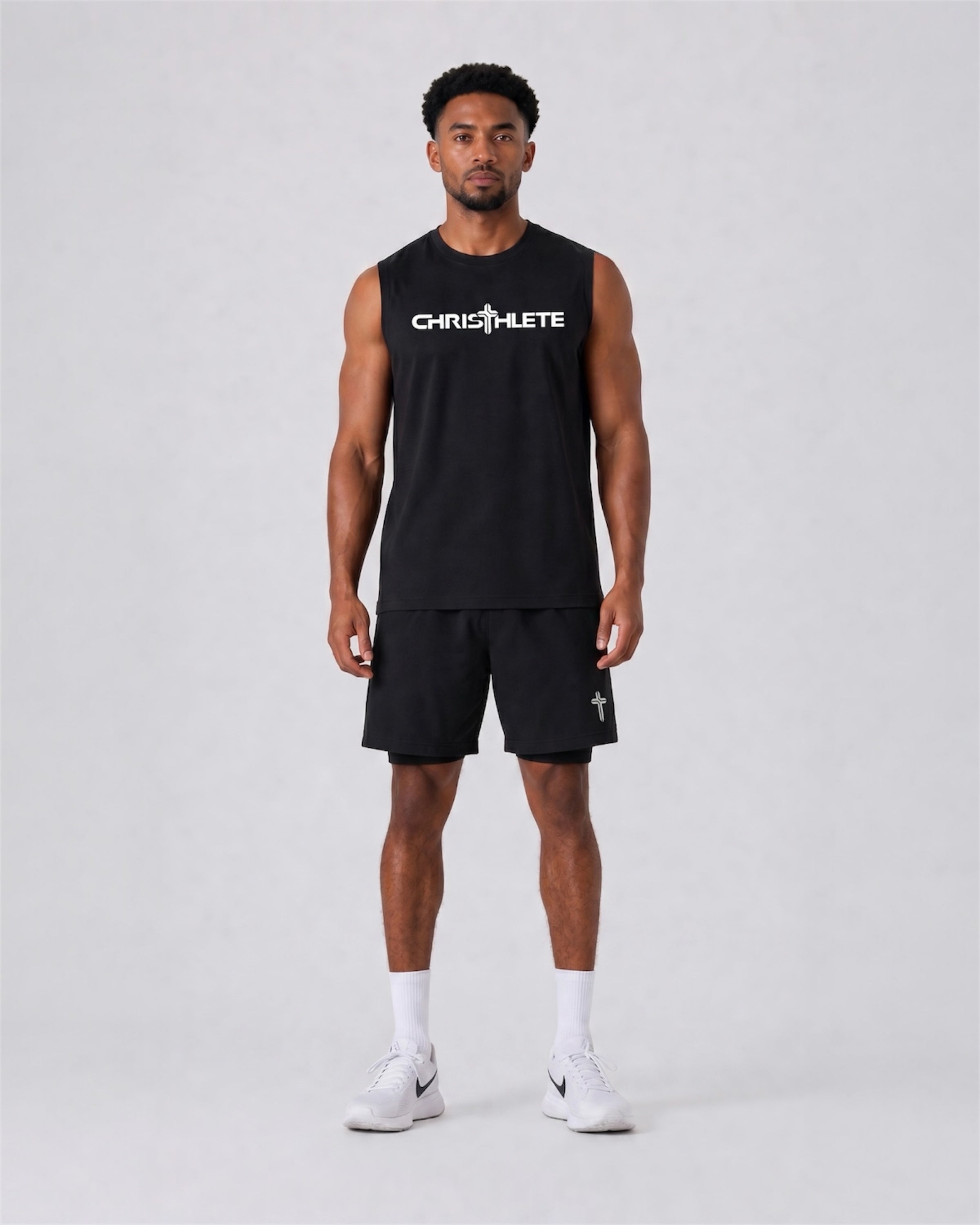 Image of Man wearing a black sleeveless shirt and shorts with 'Christhlete' branding on a white background