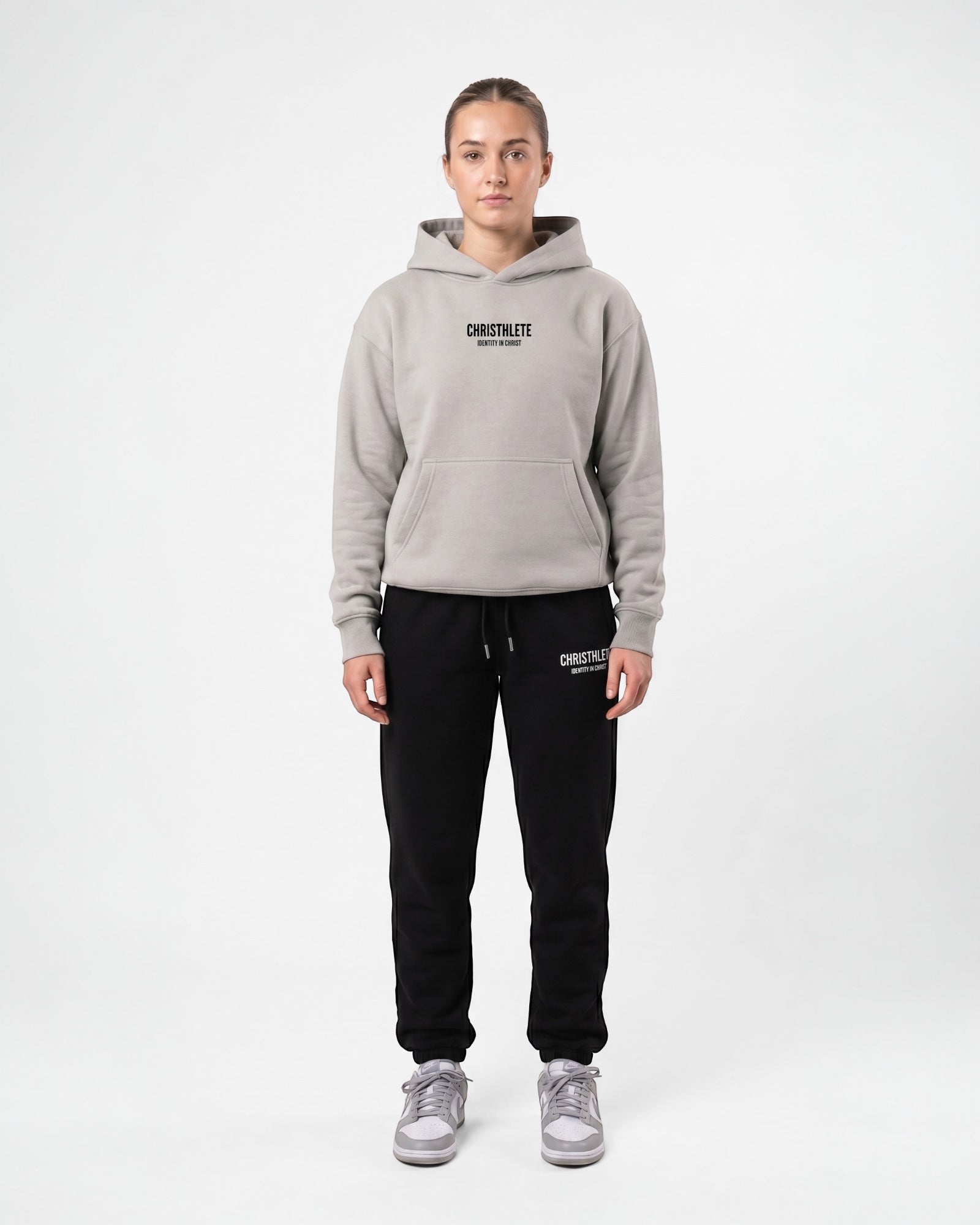 Image of Person wearing a gray hoodie and black pants with 'Christhlete' branding on a white background