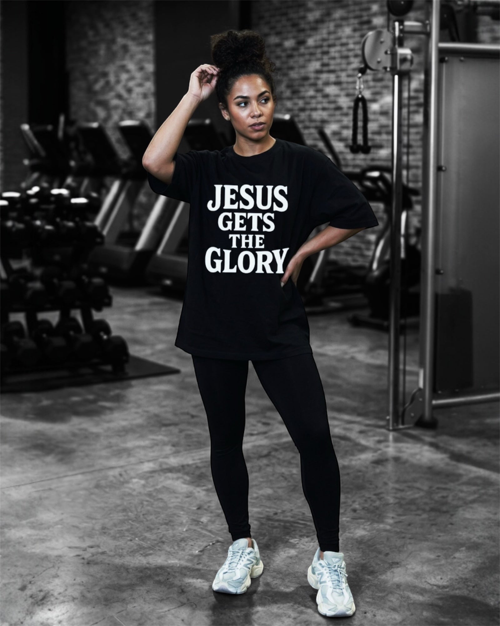 Image of Person wearing a black t-shirt with 'Jesus Gets the Glory' text in a gym setting