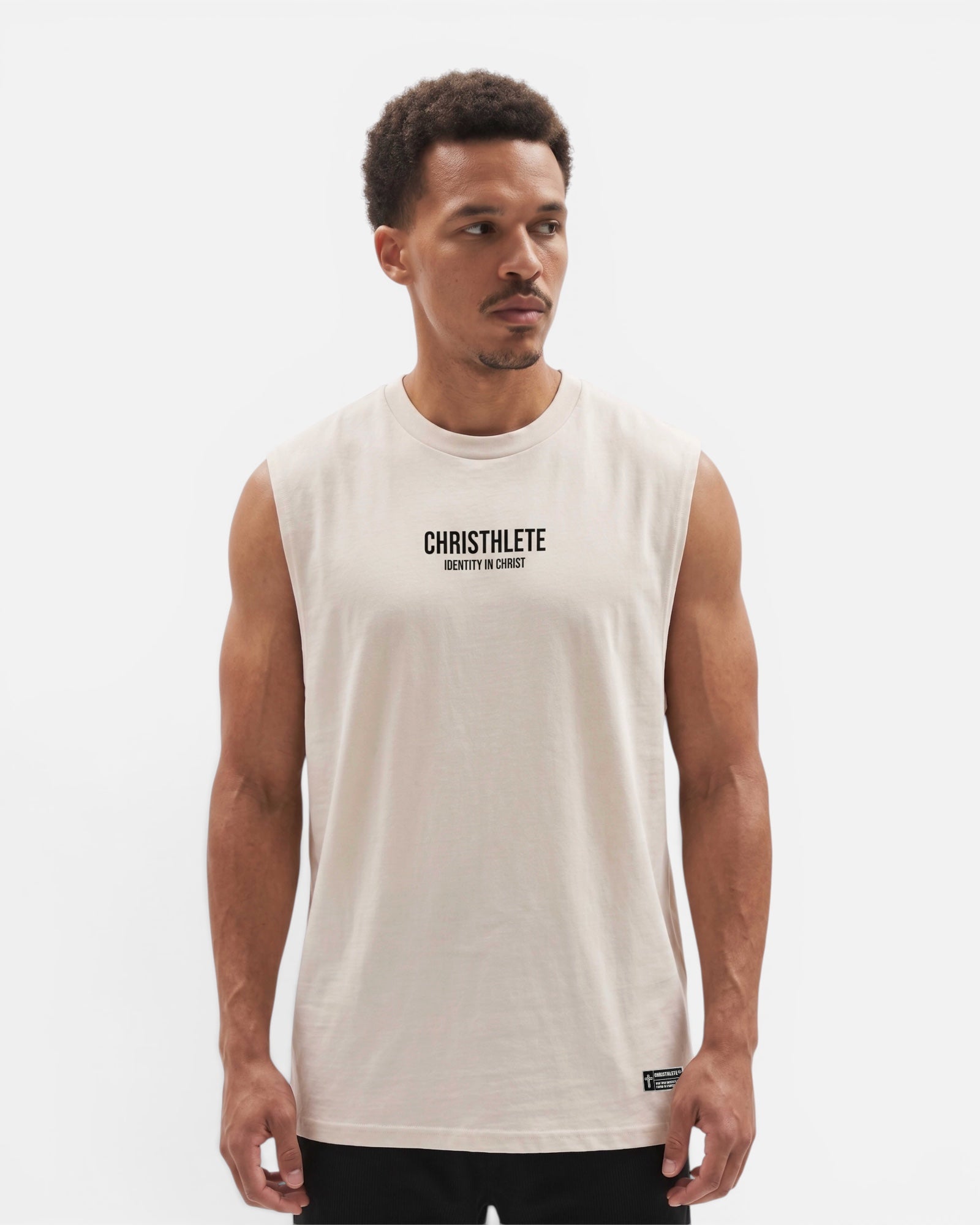 Image of Man wearing a beige sleeveless shirt with 'CHRISTHLETE' branding on a white background