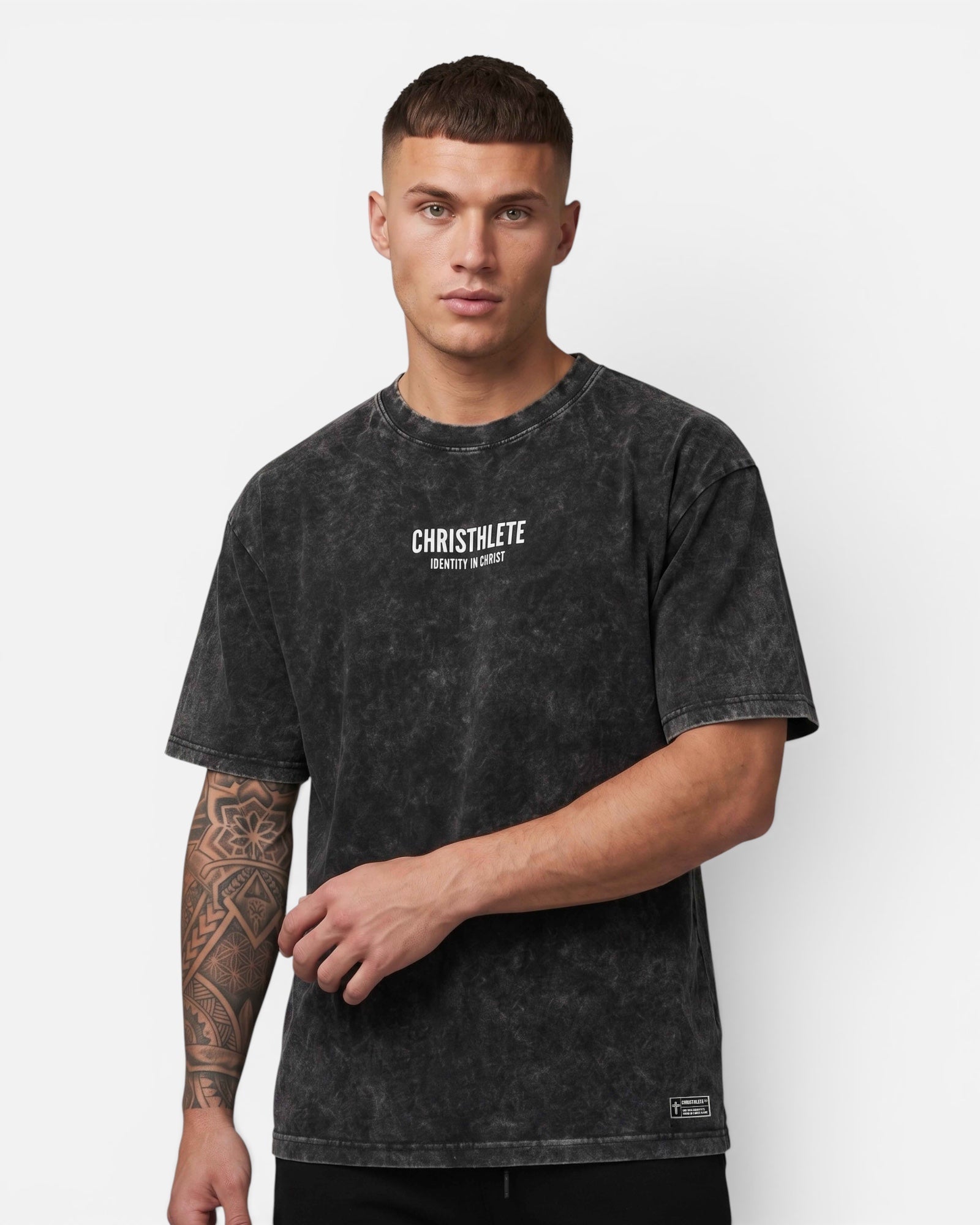 Image of Man wearing a black t-shirt with 'CHRISTHLETE' branding on a white background