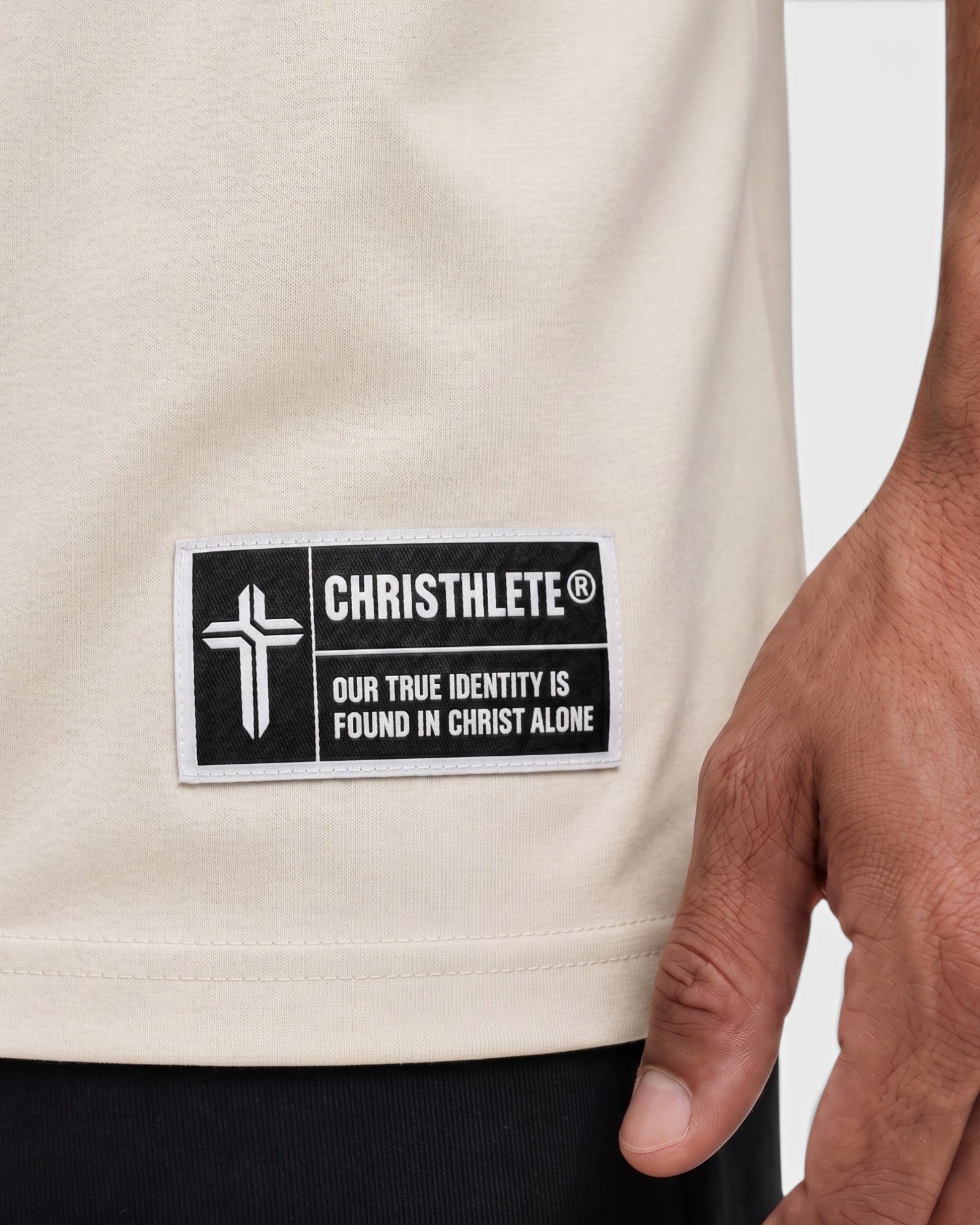 Image of Beige shirt with a 'Christhlete' label featuring a cross and text.